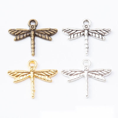 Openwork Dragonfly Metal Charms in Four Finishes in multiple metallic finishes displayed together on a white background.