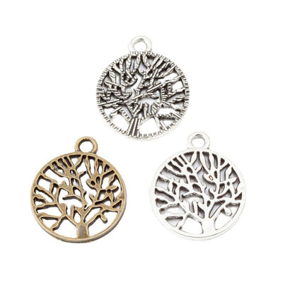 Round Openwork Tree of Life Metal Charms in Two Finishes in multiple metallic finishes displayed together on a white bac