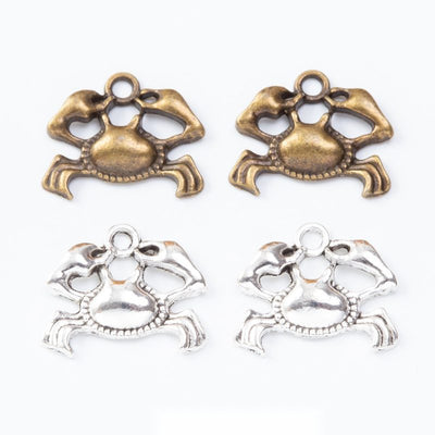 Openwork crab charms with raised claws and curved legs arranged together on a white background.