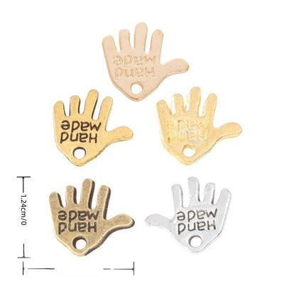 Hand Made Palm metal piece shown in Gold, Antique Bronze, Antique Silver, KC Gold, Antique Gold beside printed specifica