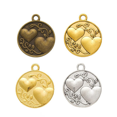 Sister Heart Disc metal piece shown in Antique Bronze, Gold, Antique Gold, Antique Silver