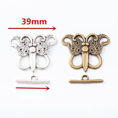 Butterfly-shaped toggle clasps with openwork wings arranged together on a white background.