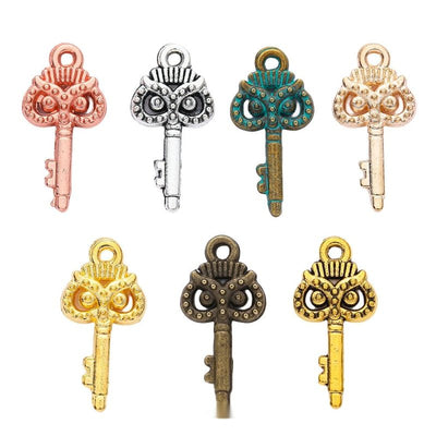 Ornate Owl Top Key Metal Charms in Seven Finishes in multiple metallic finishes displayed together on a white background
