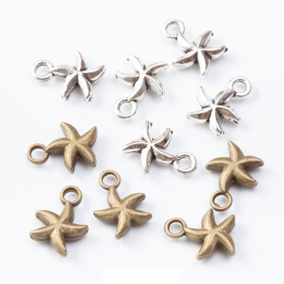 Five-arm starfish charms with softly raised center details arranged together on a white background.