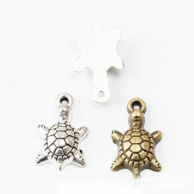 Small Turtle Metal Charms in Two Antique Finishes in multiple metallic finishes displayed together on a white background