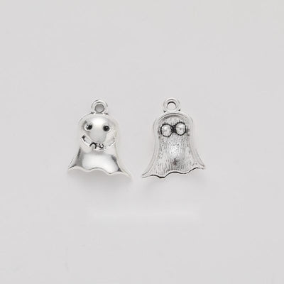 small smiling ghost metal charm shown from the front in the available metallic finishes