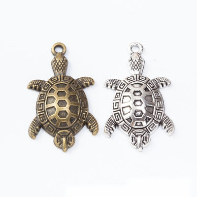 Turtle Charm Pendant finish comparison showing a patterned shell, four flippers, and a small tail
