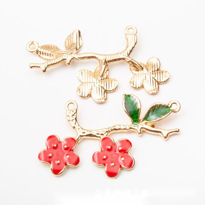 Product view of blossom branch connector showing a curved gold-tone branch with two red blossoms, green leaves, and loop