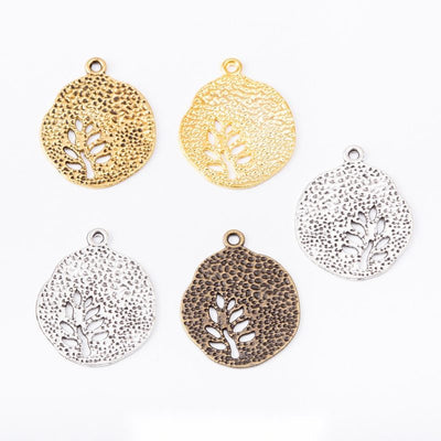 Finish comparison of 圆片镂空生命树 charm on a white background