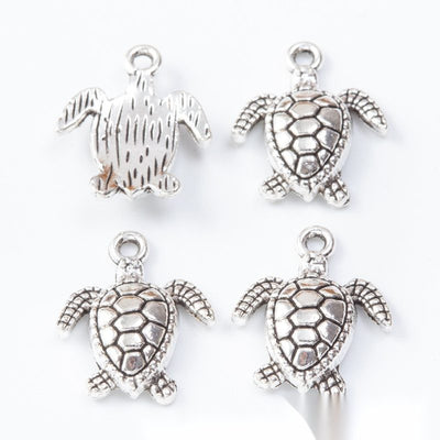 Group view of the sea turtle charm showing the available finishes and front details