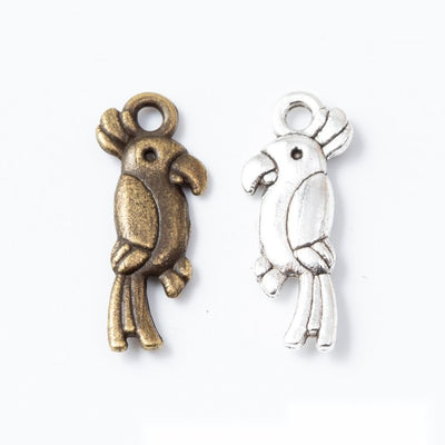 Long Tailed Bird Charm Pendant finish comparison showing a crested bird profile with a long split tail