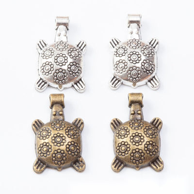 Floral Shell Turtle metal pieces shown in the available finishes.