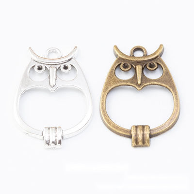 Group view of the owl charm showing the available finishes and front details