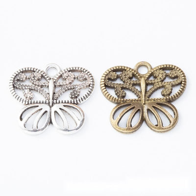 Group view of a symmetrical butterfly silhouette has open scrollwork wings
