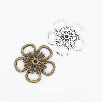 Product view of flower connector showing an open five-petal flower with a layered floral center and petal loops