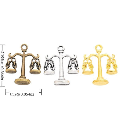 Overview of balance scale charm pieces on a white background