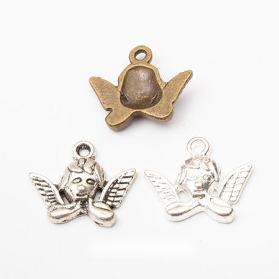 Front and finish comparison of winged cherub charm