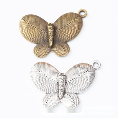 Group view of butterfly silhouette with engraved wing texture and top loop