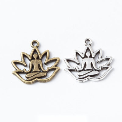 Product photo 1 of the yoga lotus charm highlighting its open lotus blossom with a seated figure at center