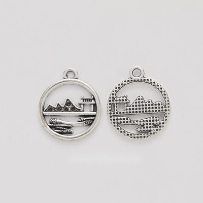 Round Landscape House Charm shown in all pictured finishes on a white background