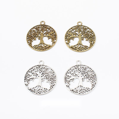 Assorted round tree of life charm pendants displayed together on a white background