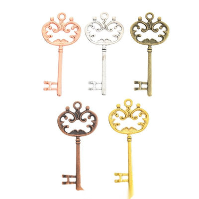 Group view of the ornate key charm showing the available finishes and front details