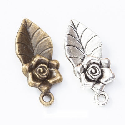 Group view of the rose and leaf charm showing the available finishes and front details