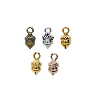 Overview of acorn charm pieces on a white background