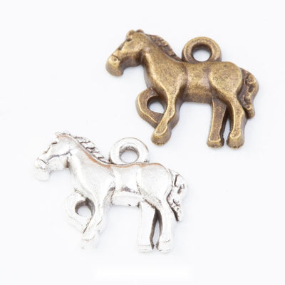 standing horse metal charms in two antique finishes shown together in the available finishes
