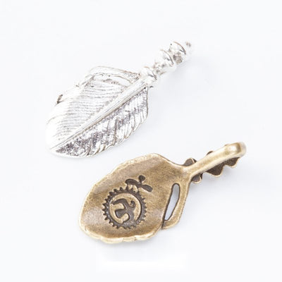 Spiral Detailed Feather metal piece shown in Antique Bronze, Antique Silver