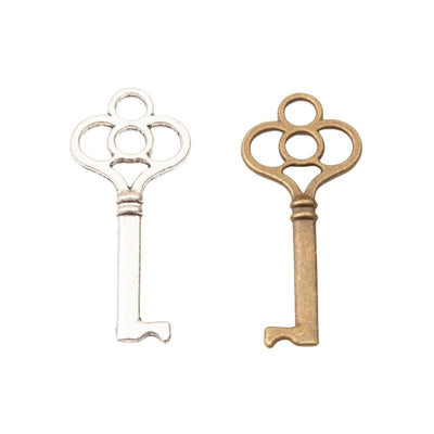 Grouped front view of skeleton key charm showing a four-loop bow, ribbed neck, and short bit