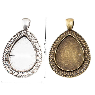 Ornate Teardrop Cabochon Pendant Trays in Two Finishes in multiple metallic finishes displayed together on a white backg