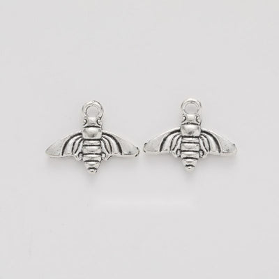 Grouped front views of the small bee charm in available finishes