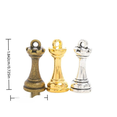Grouped front view of chess queen charm showing a dimensional crown, tapered body, and round base