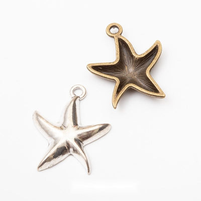 sculpted starfish metal charms in two antique finishes shown together in the available finishes