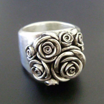 Product view showing antiqued silver-tone sculpted rose extra-wide ring