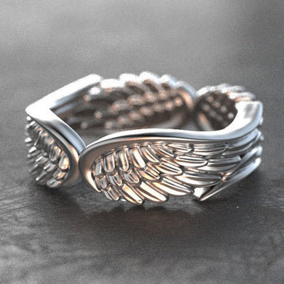 Silver angel wing feather band ring front three-quarter view
