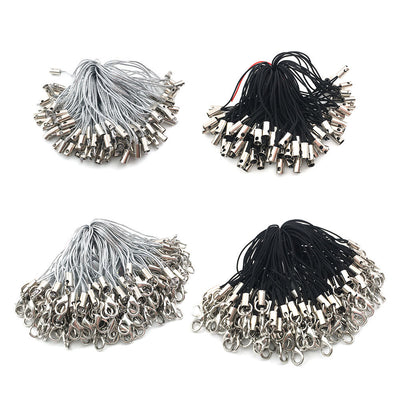 Metallic lobster clasp jewelry findings arranged on a light background