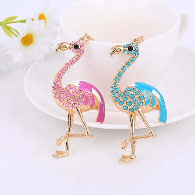 Pink and blue rhinestone flamingo charms side by side