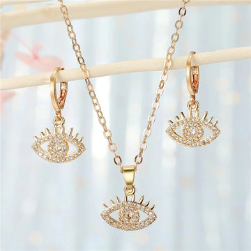 Gold Tone Crystal Evil Eye Pendant Necklace and Huggie Earrings