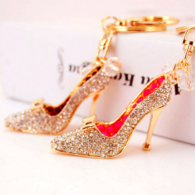 Pink and dark brown high heel shoe charms displayed with gold-tone keychain hardware.
