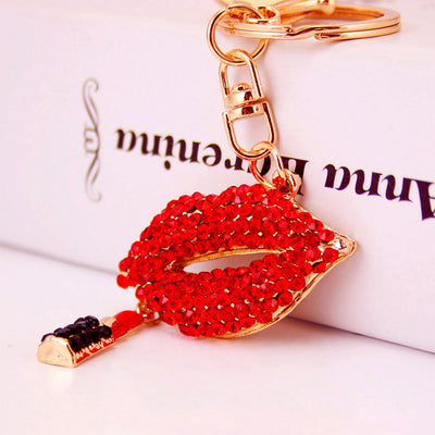 Close-up of the red stone-covered lips charm with a red and black lipstick dangle.