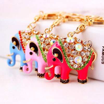 Three colorful elephant keychains displayed together in blue, pink, and fuchsia.
