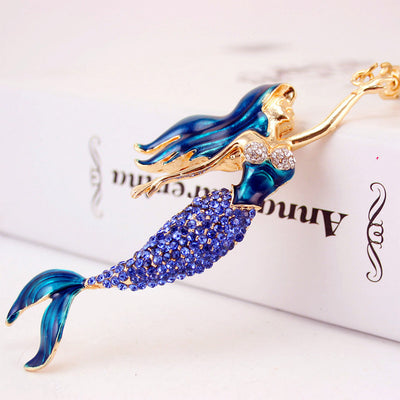 Close-up of a blue mermaid figure covered with blue and clear rhinestones.
