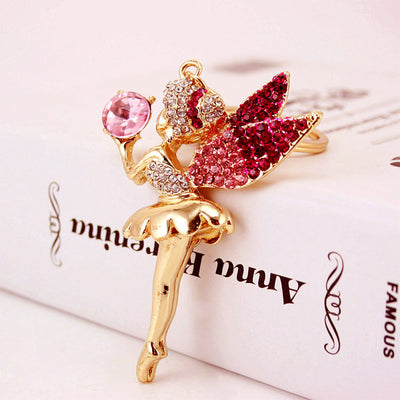 Close-up of the pink stone fairy charm resting beside its split ring.