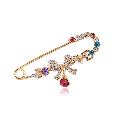 Front product view of the ribbon bow brooch pin in gold and silver