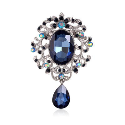 Front product view of the ornate oval crystal dangle brooch pin in silver and blue
