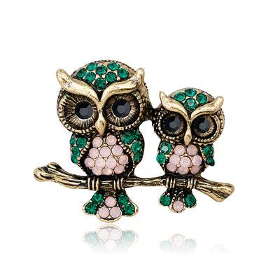 Front product view of the owl brooch pin in gold and black