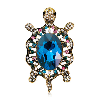 Front product view of the turtle brooch pin in gold and blue