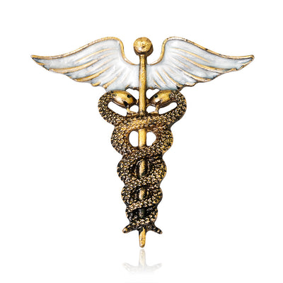 Front product view of the winged caduceus brooch pin in gold and silver